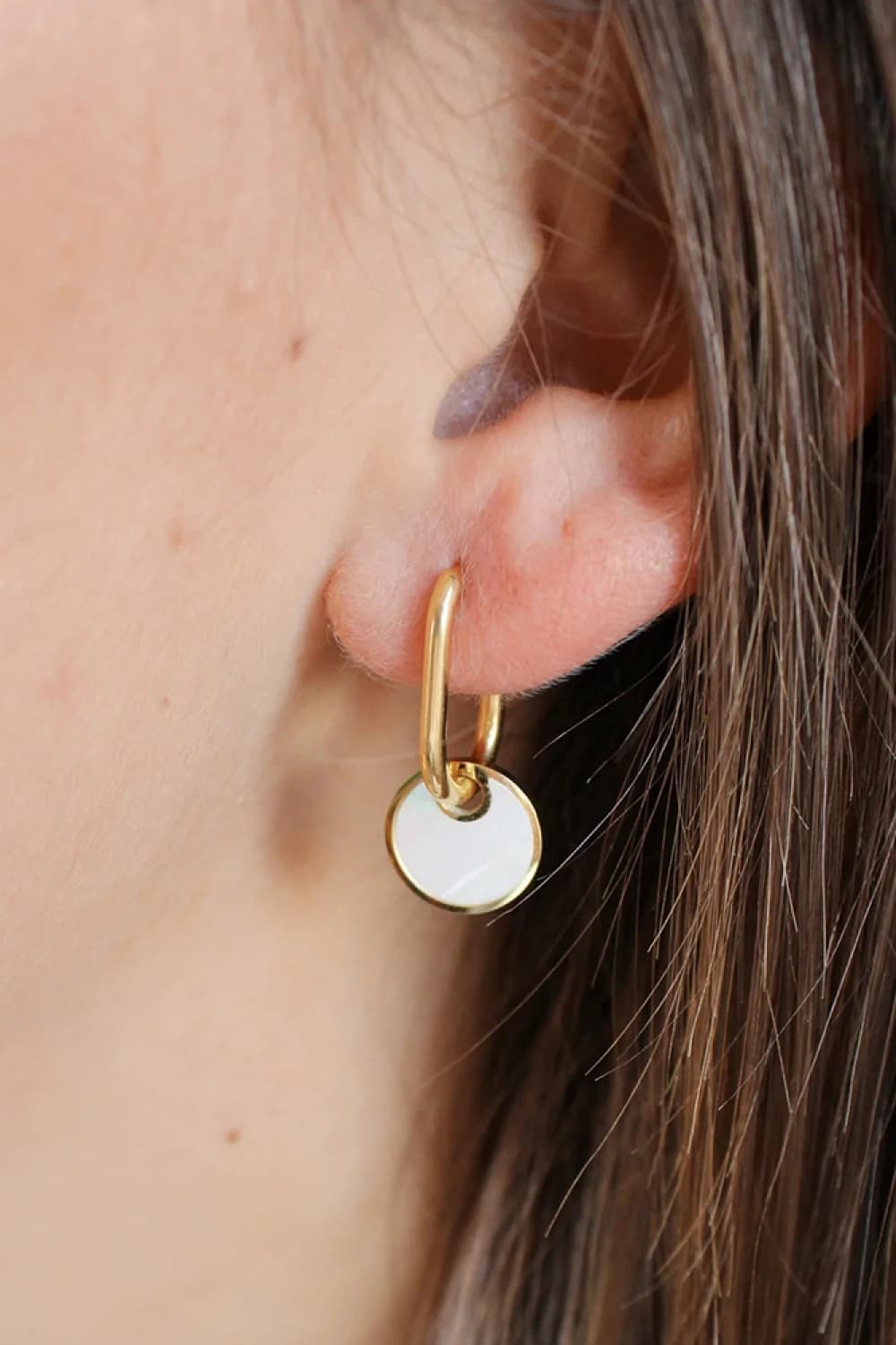 Gold hoop earrings with mother-of-pearl disc drops