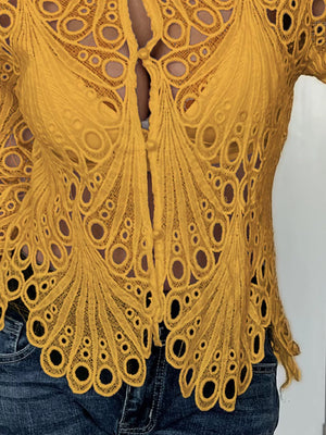 Yellow lace button-up blouse with scalloped collar and intricate peacock feather pattern.