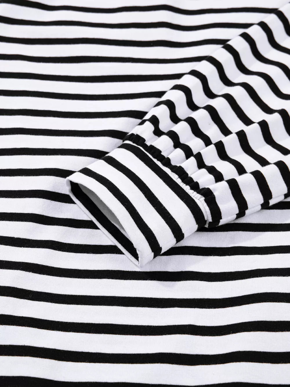 Black and white striped collared long sleeve dress with button detail on cuff.