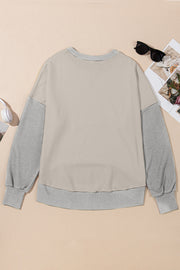 Chic Contrast Crewneck Sweatshirt in tan with gray sleeves and ribbed cuffs.