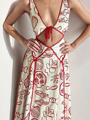 Backless maxi dress with oceanic print, cutout, and tie-front detail.