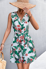 White floral mini dress with zip-front, tie waist, and sleeveless design.