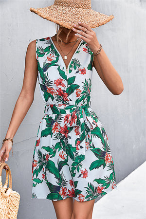 White floral mini dress with zip-front, tie waist, and sleeveless design.