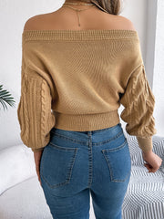 Camel cable knit off-shoulder crop sweater with textured sleeves.