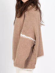 Camel oversized knit cardigan with contrast white trim detail on sleeves and hem.