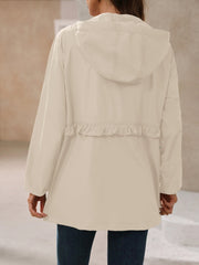 Tan hooded windbreaker jacket with ruffled waistline detail
