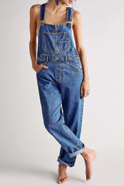 Relaxed fit medium wash denim overalls with crisscross straps and a bib pocket.