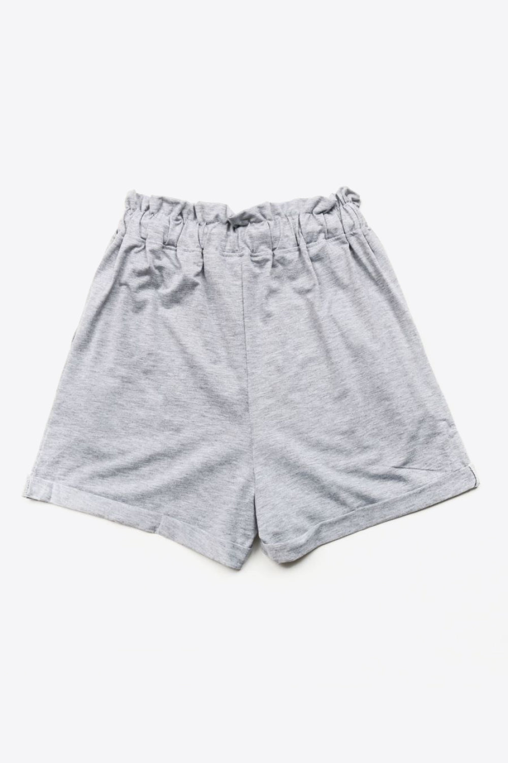 Light gray paperbag waist shorts with decorative buttons and a comfortable fit.
