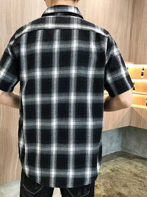 Black plaid oversized short sleeve cotton overshirt with button-down detail.