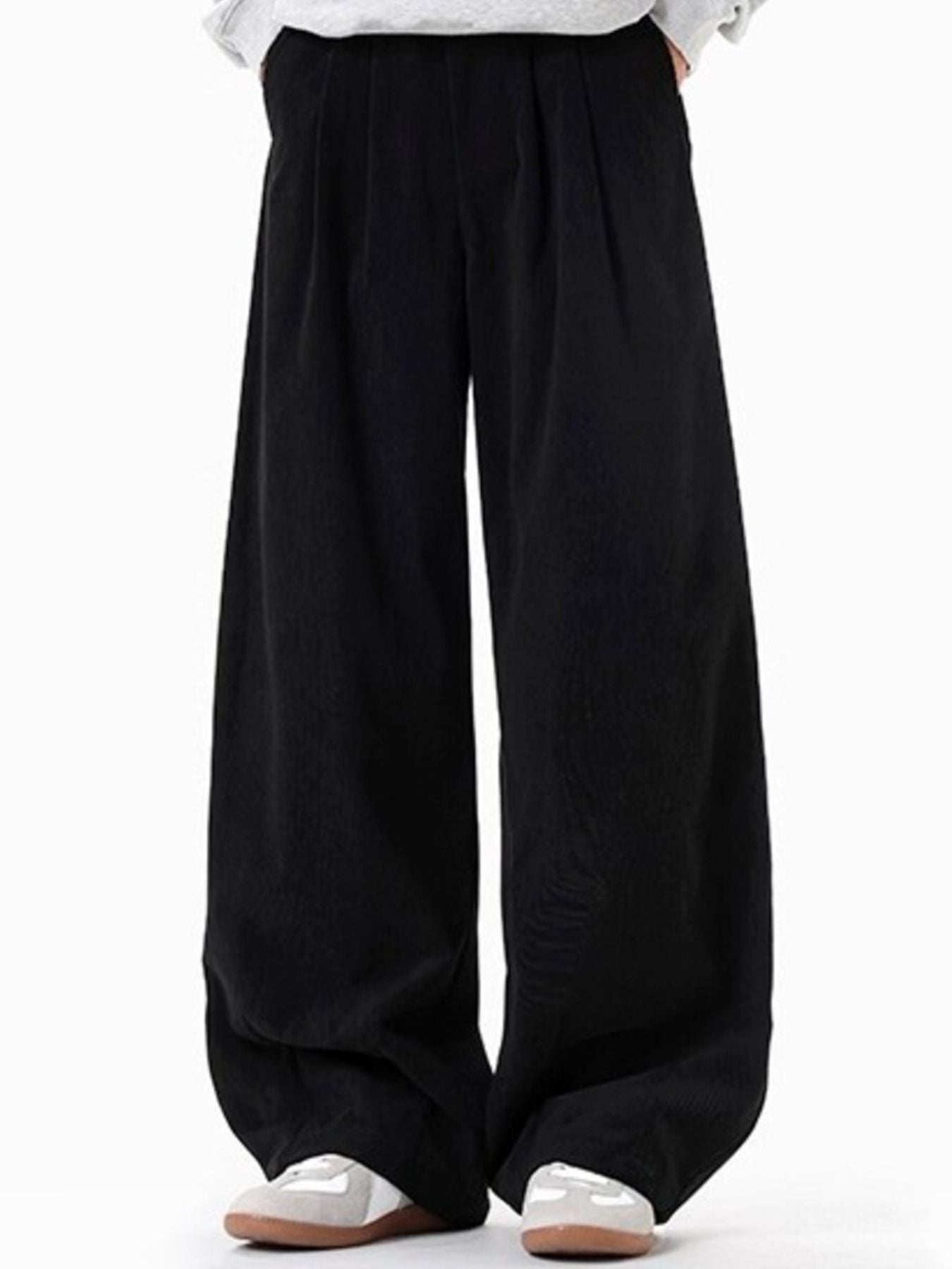 Men's black pleated wide leg trousers with a casual fit.