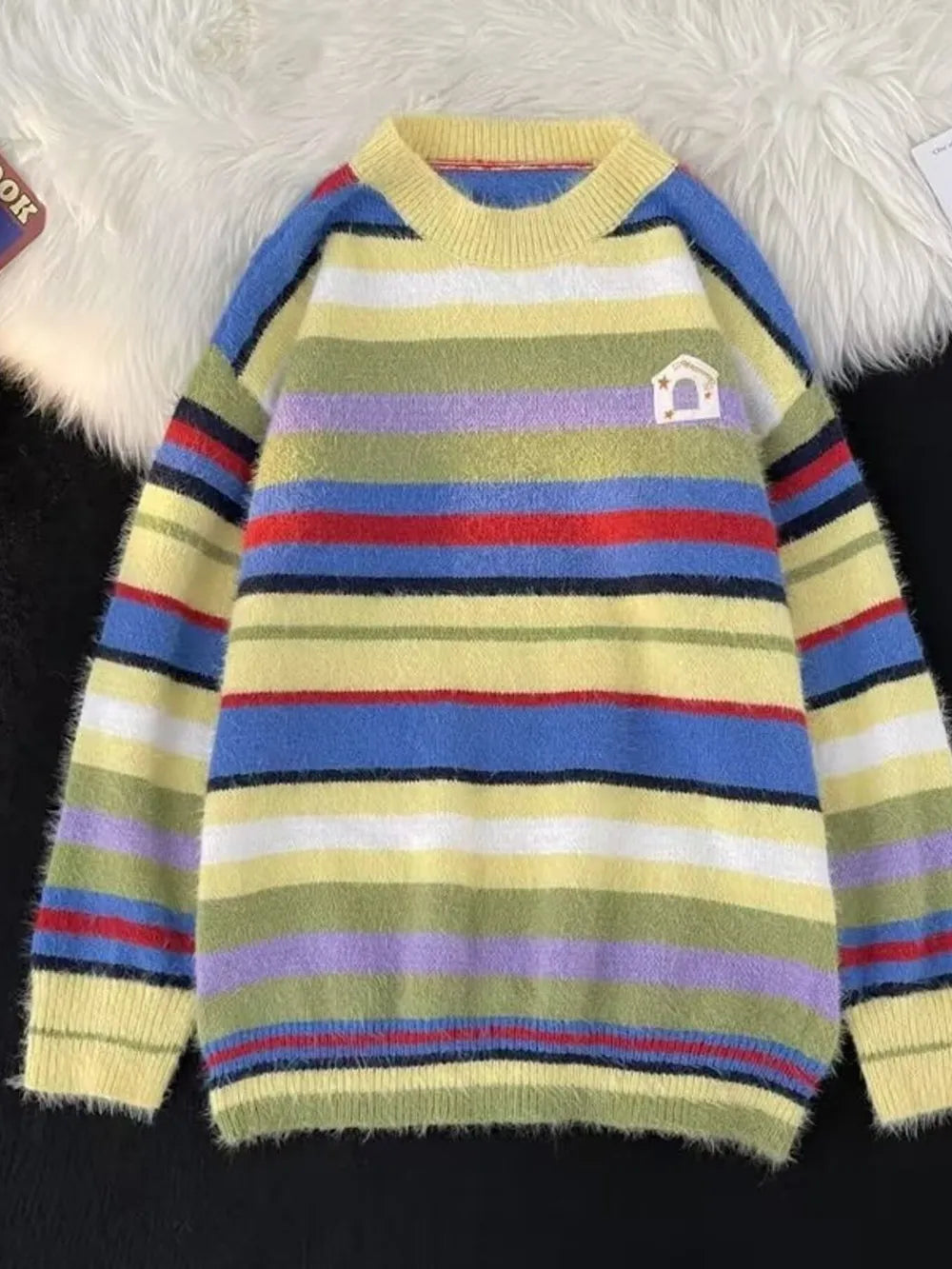 Cozy multi-striped knit sweater for men with crew neck and fuzzy texture.