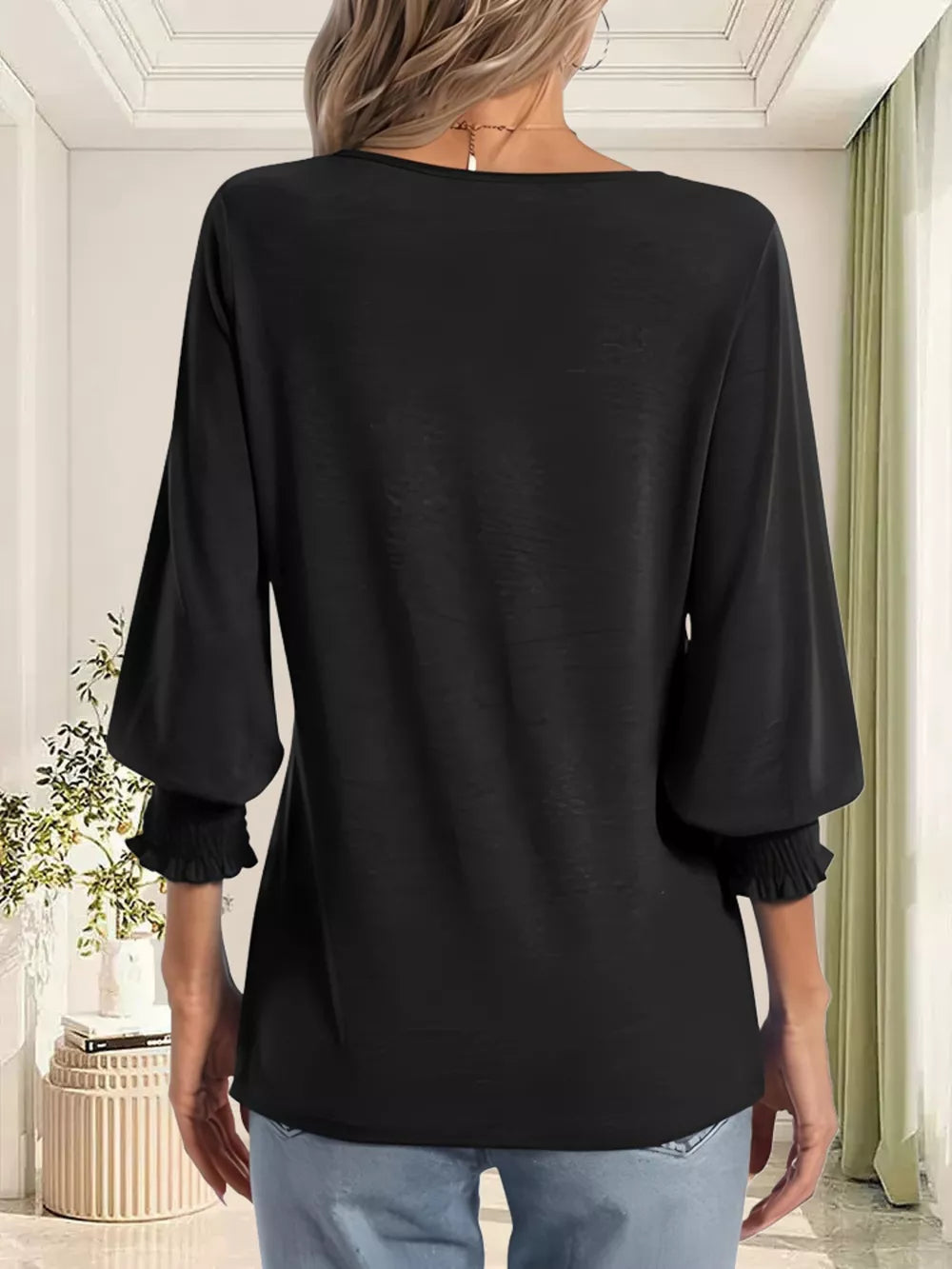 Black maternity t-shirt with ruched 3/4 sleeves and a notched neckline.