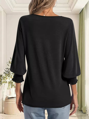 Black maternity t-shirt with ruched 3/4 sleeves and a notched neckline.