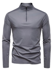 Gray performance zip-neck tee with structured shoulders and long sleeves.