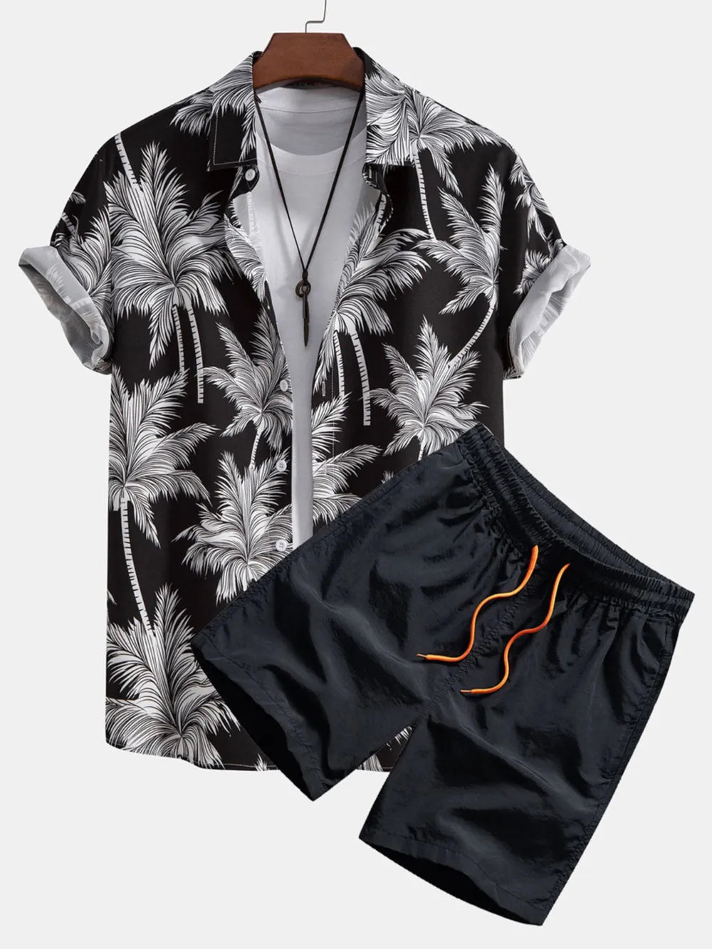 Men's black tropical print button-down shirt and dark navy shorts with orange drawstring.