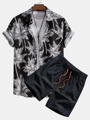Men's black tropical print button-down shirt and dark navy shorts with orange drawstring.