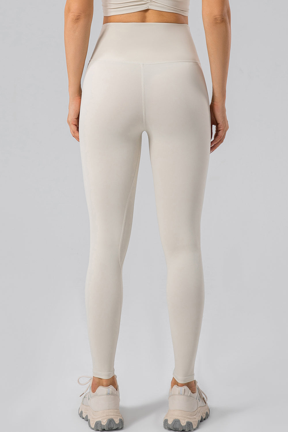 Ivory high-waist performance leggings with contouring seams and a seamless waistband.
