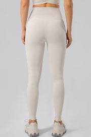 Ivory high-waist performance leggings with contouring seams and a seamless waistband.