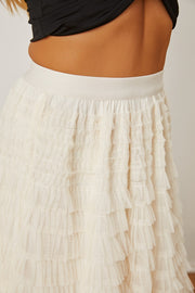 Tiered tulle maxi skirt in ivory with ruffled layers and a comfortable elastic waistband.