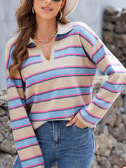 Beige knit polo sweater with deep V neckline and horizontal pink, blue, and grey stripes.