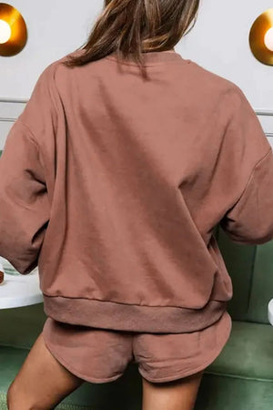 Taupe loungewear set with oversized sweatshirt and dolphin shorts.