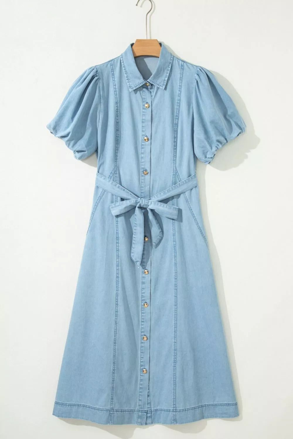 Light blue denim midi dress with collar, puff sleeves, button front, and tie belt.