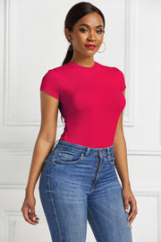 Hot Pink sculpted crew neck bodysuit with short sleeves, styled with blue jeans.
