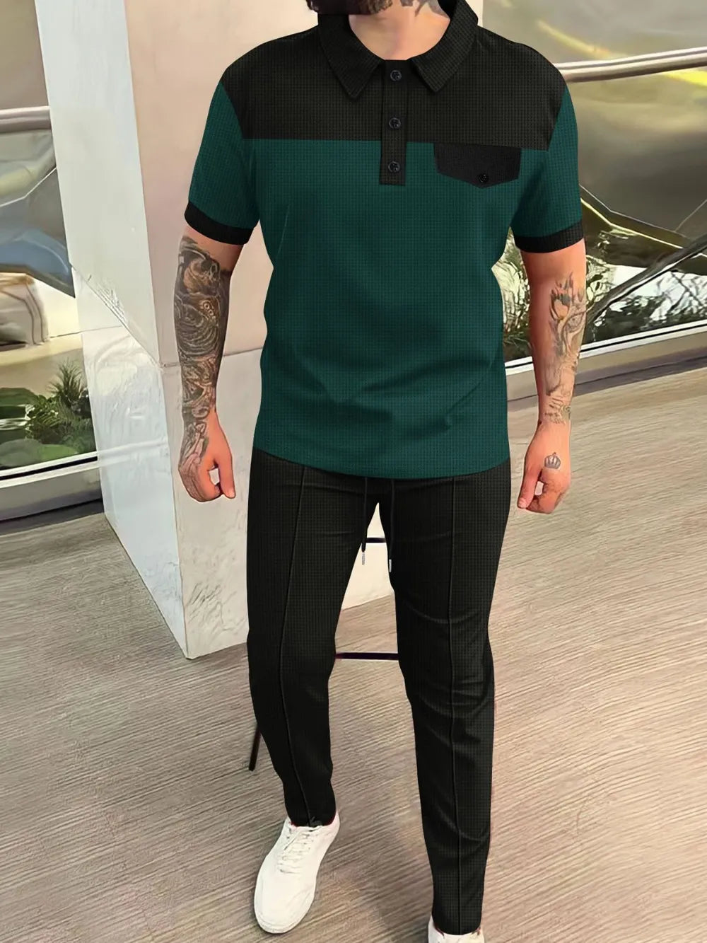 Dark green and black colorblock polo shirt with pocket and matching track pants.