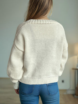 Beige knit cardigan with balloon sleeves and ribbed trim.