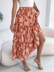 Orange floral midi skirt with tiered ruffles and asymmetrical hem.