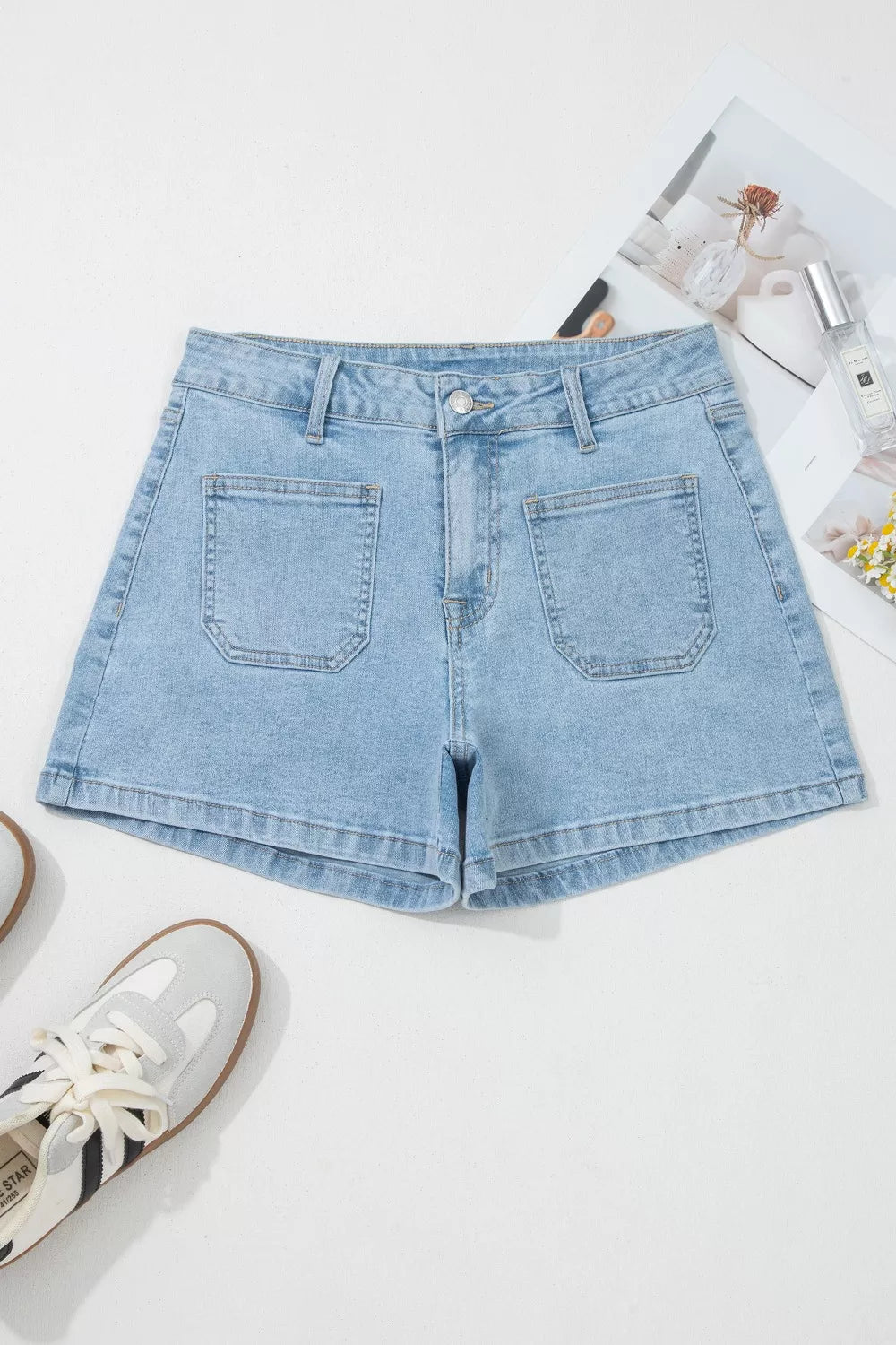 Light wash denim shorts with high rise and patch pockets.