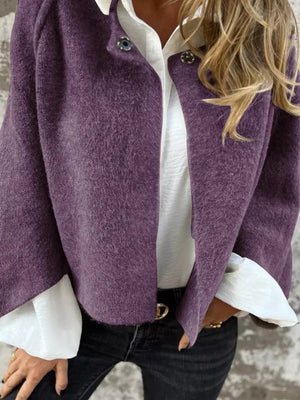 Purple fuzzy knit cardigan with button detail, open front, worn over white shirt.