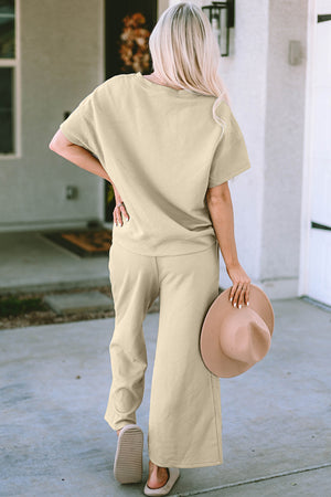 Beige textured knit tee and wide leg pants set with short sleeves and a relaxed fit.