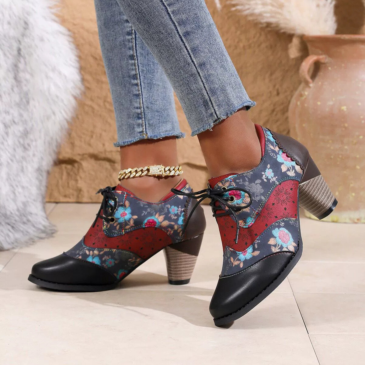 Floral patchwork lace-up ankle boots with block heel and scalloped trim.