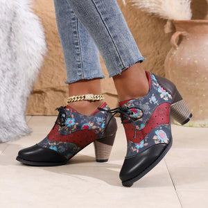 Floral patchwork lace-up ankle boots with block heel and scalloped trim.