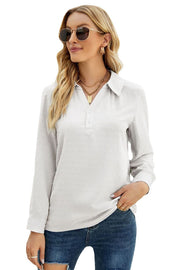 White textured collared blouse with button placket and long sleeves.