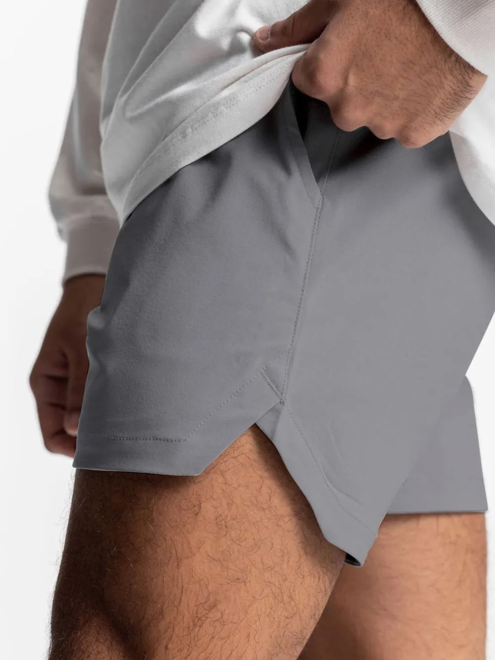 Gray performance drawstring running shorts with side slits and pockets.