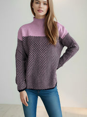 Chevron knit turtleneck sweater in lavender and black with a herringbone pattern.