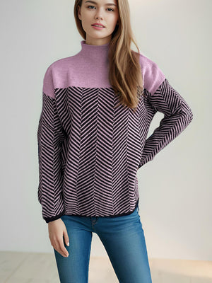 Chevron knit turtleneck sweater in lavender and black with a herringbone pattern.