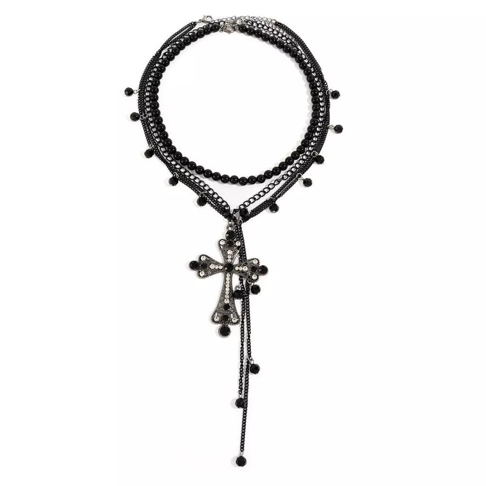 Black layered necklace with beaded strands and a crystal-embellished cross pendant.