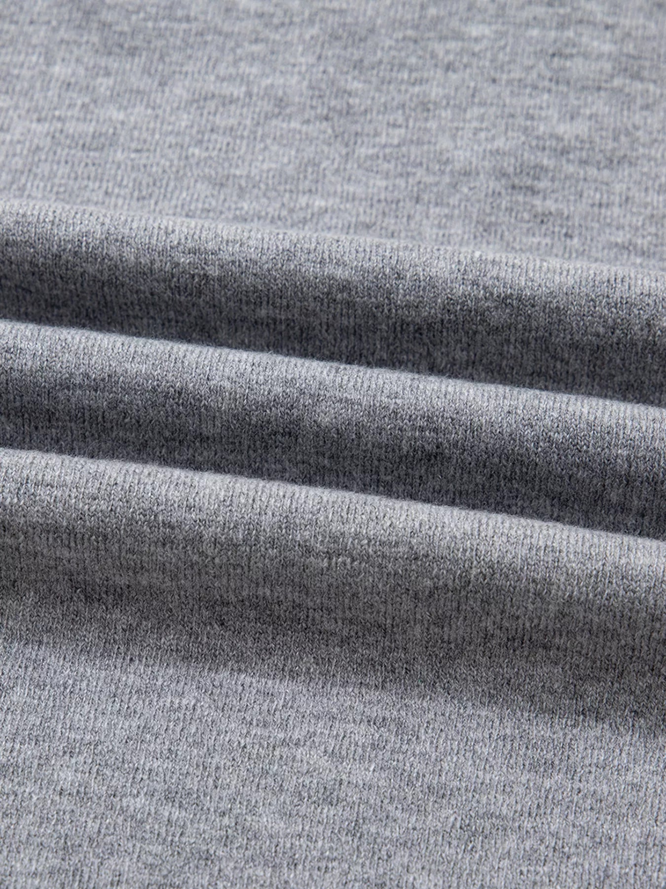 Gray ribbed V-neck sweater fabric detail
