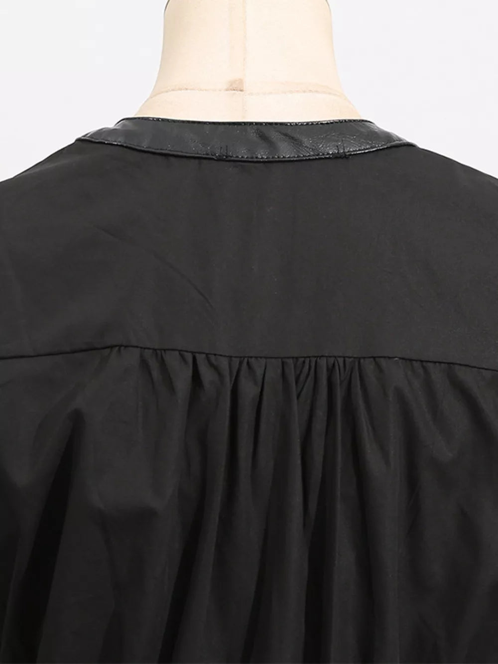 Black midi dress with faux leather collar and gathered waist detail.