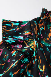 Black abstract print blouse with ruffled aura sleeves and mock neck.