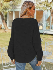 Black textured puff sleeve blouse with V-neck, casual style.