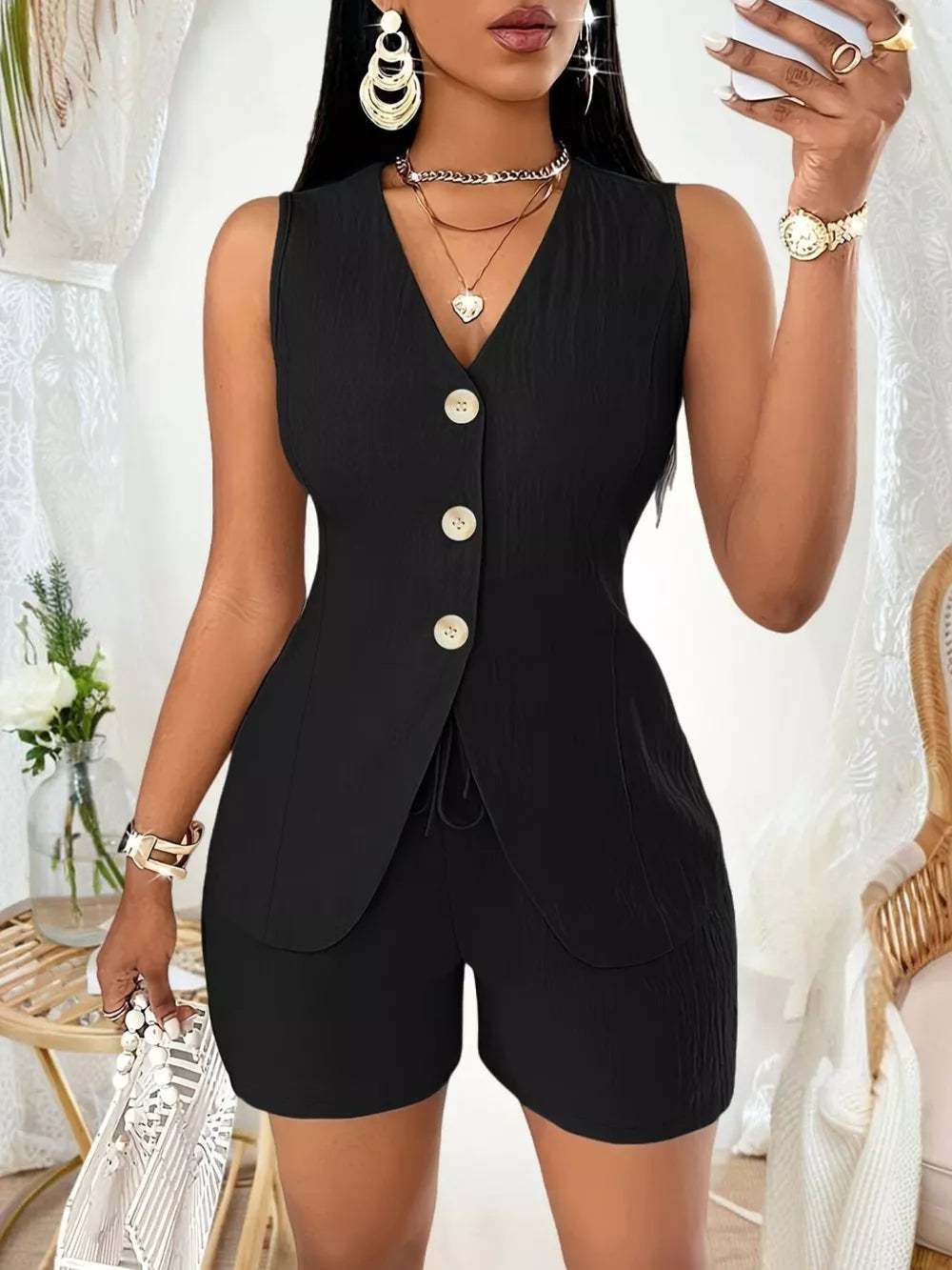 Black button-down vest and shorts set with drawstring detail and textured shorts.