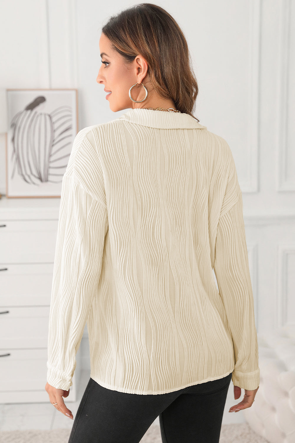 Beige oversized button-down shirt with a textured pleated pattern and long sleeves.