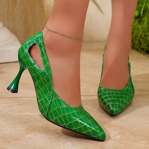 Green crocodile-embossed pointed heel pumps with cut-out detail and unique flared heel.