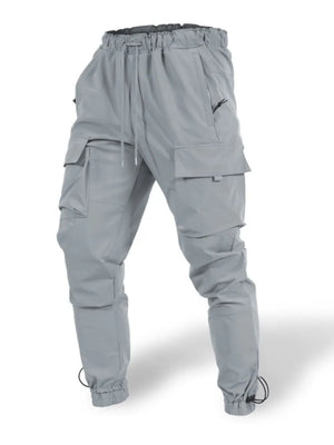 Gray tech-utility cargo joggers with drawstring waist and ankle cuffs, multiple pockets.