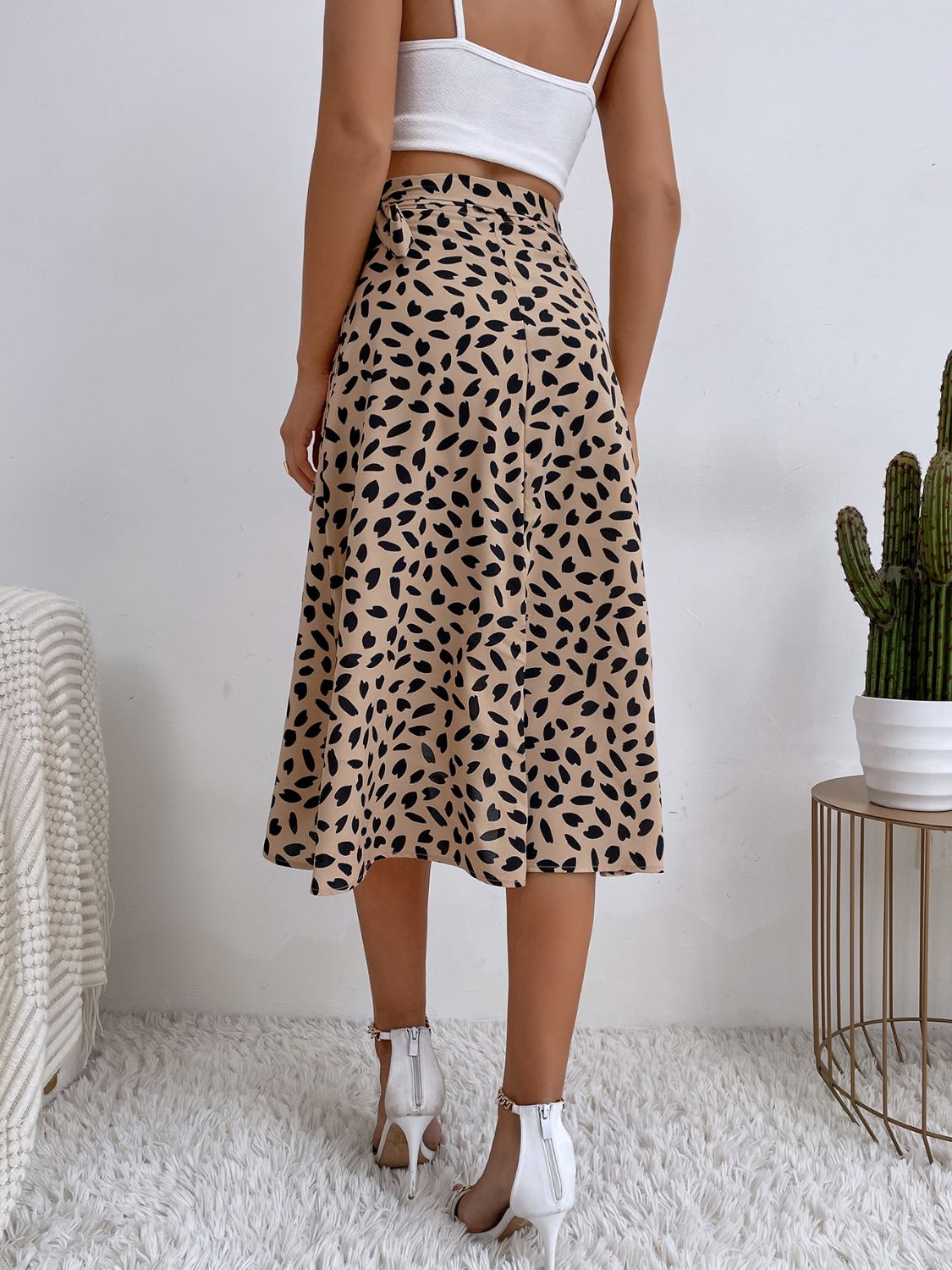 Asymmetric wrap skirt in tan with abstract print and tie waist detail.