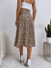 Asymmetric wrap skirt in tan with abstract print and tie waist detail.